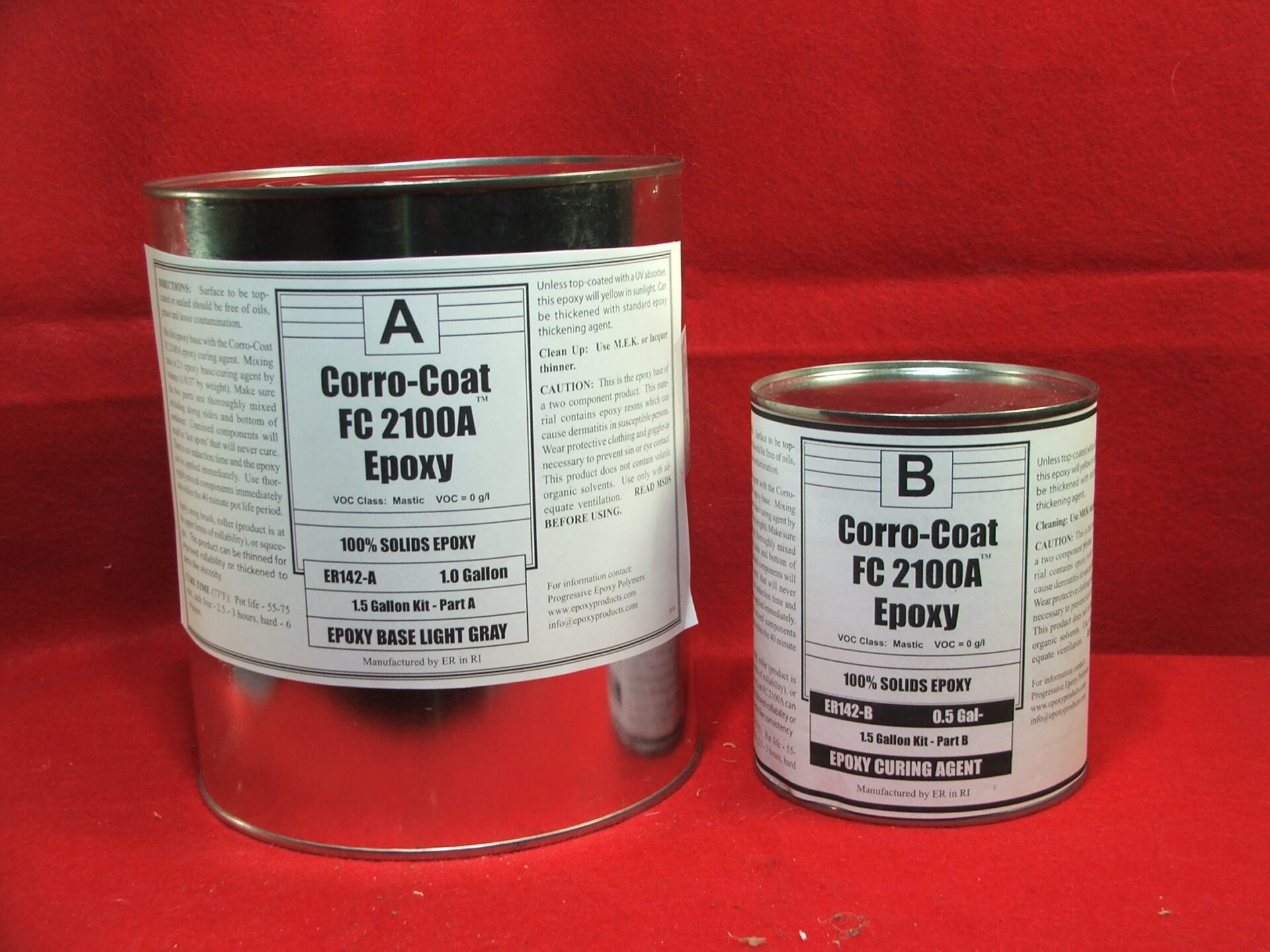 two tubs of epoxy set on a red cloth